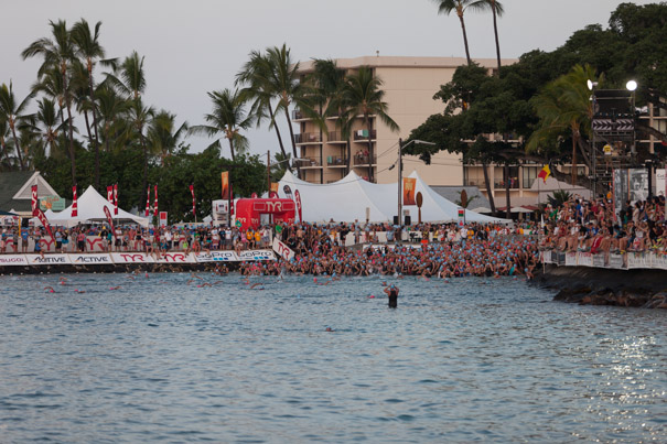 Age group swimmers on the beach and heading into the water.