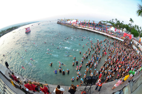 Age group swimmers on the beach and heading into the water.