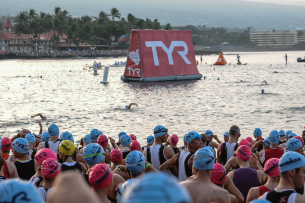 Age group swimmers on the beach and heading into the water.