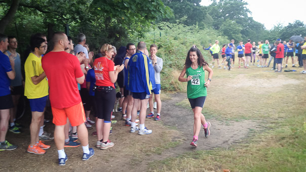 One of the earlier runners sets off as almost everyone else hides from the rain under a tree!